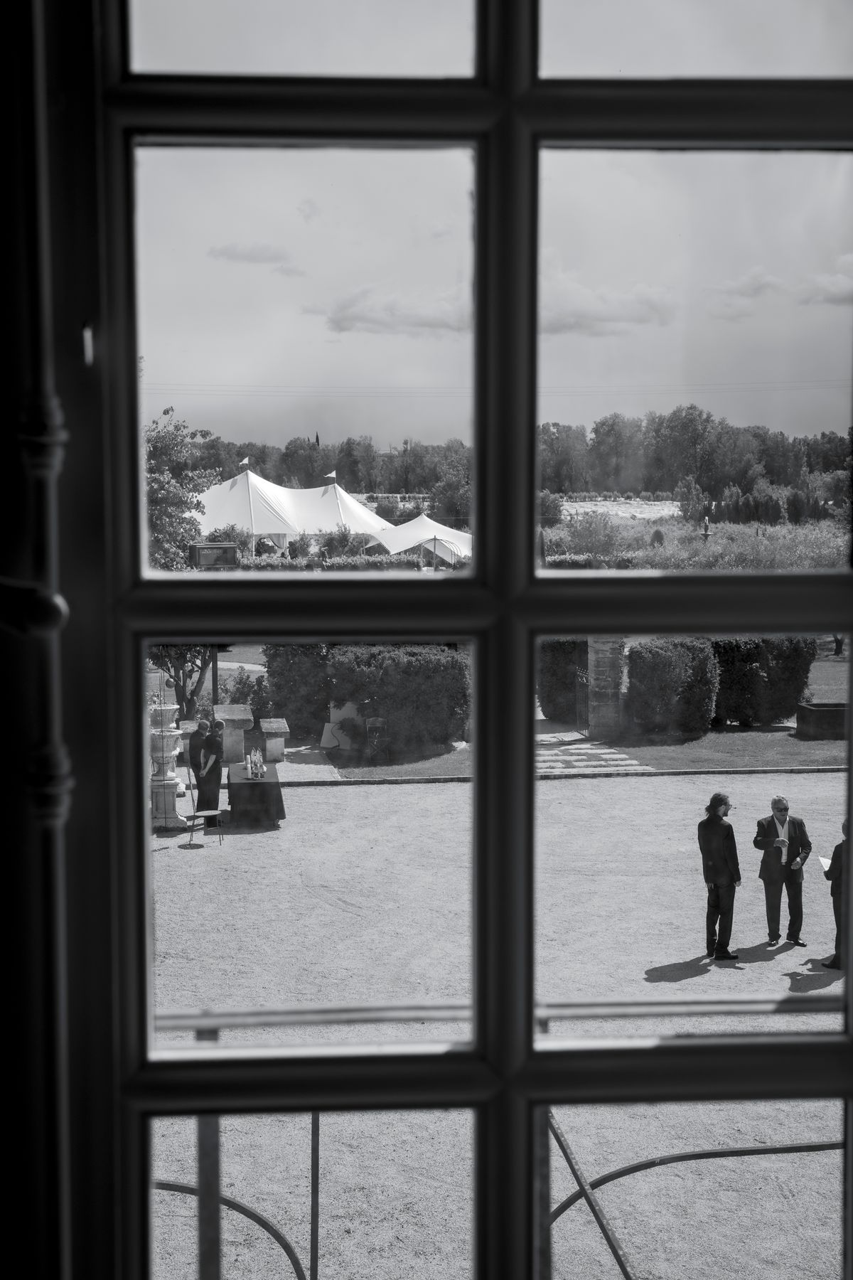 View from inside the château through a window onto the marquee and courtyard