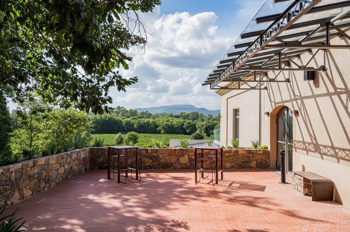 Domaine de Blacailloux terrace with terracotta paving, bar seating and vineyard views in Provence