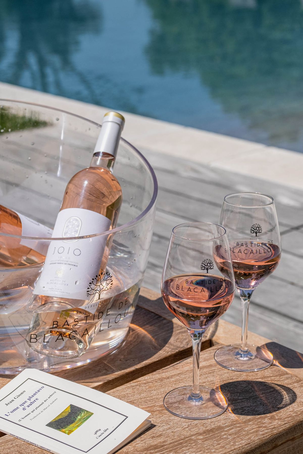 Bastide de Blacailloux rosé in ice bucket with branded glasses poolside at the estate