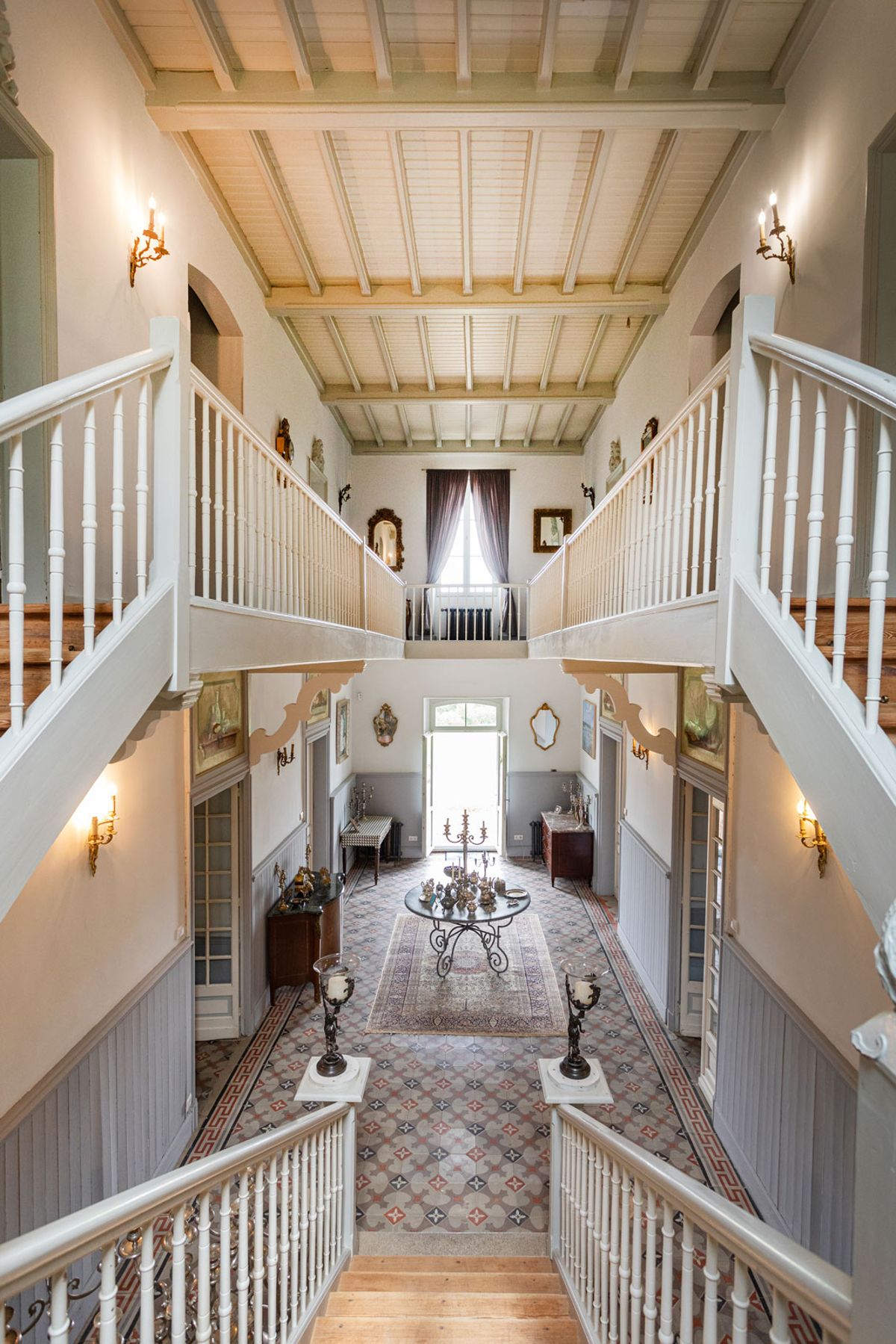The double staircase and entrance hall seen from the upper landing
