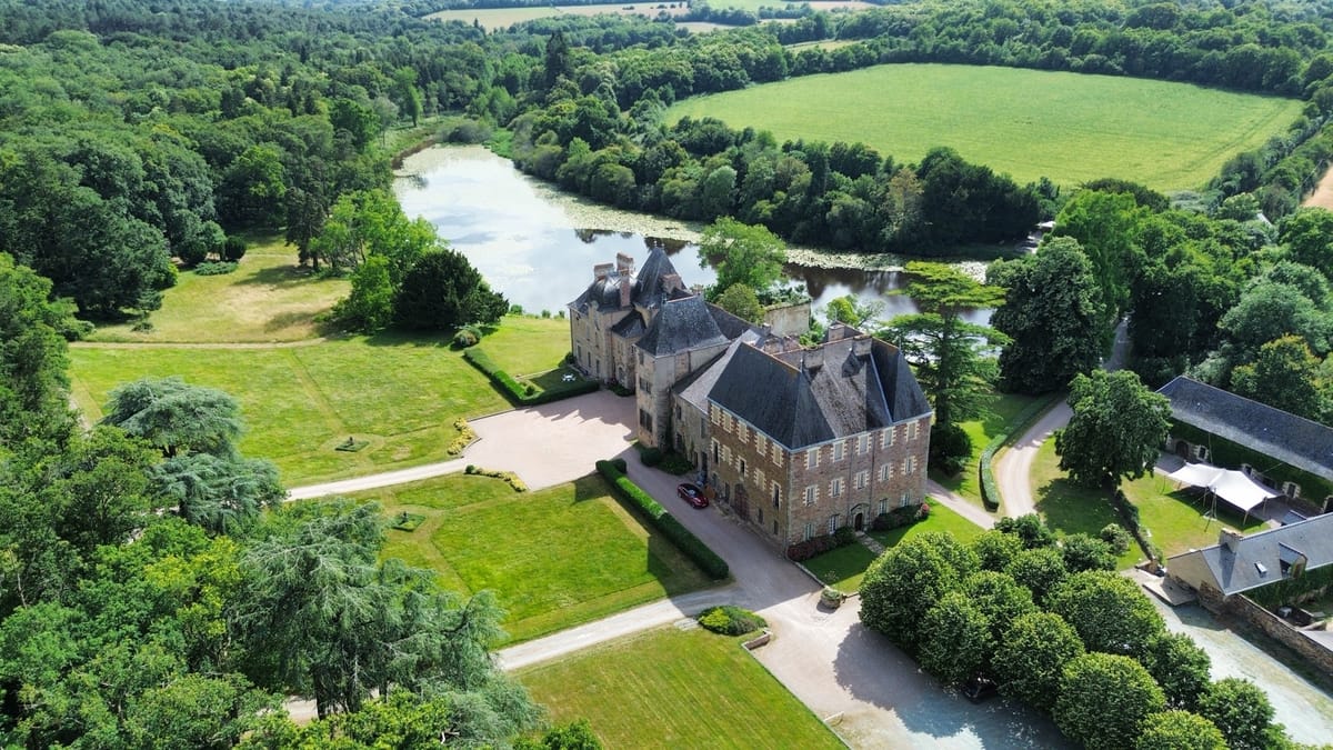 Aerial view of Chateau du Pordor from the east, with the drive, the lake and the surrounding parkland