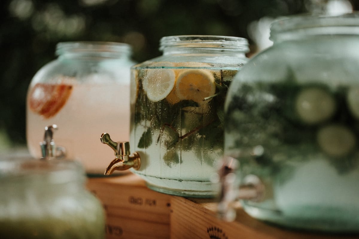 Glass drink dispensers with infused water and lemonade at a Chateau du Pordor drinks station