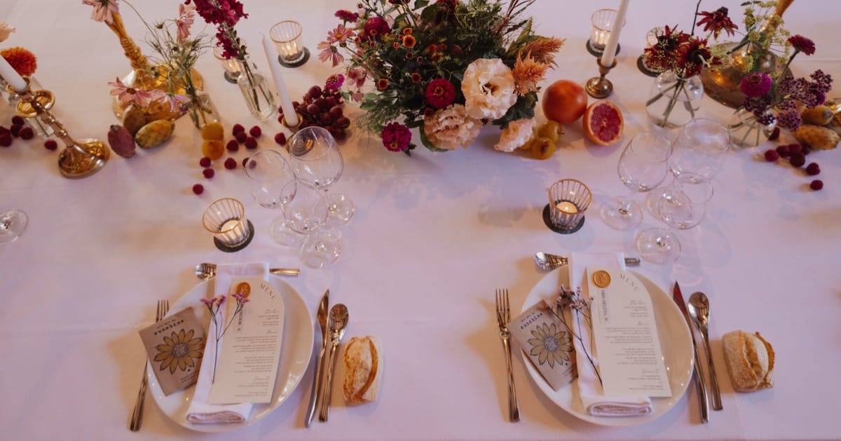 Place settings and autumn flowers on a wedding table at Chateau du Pordor