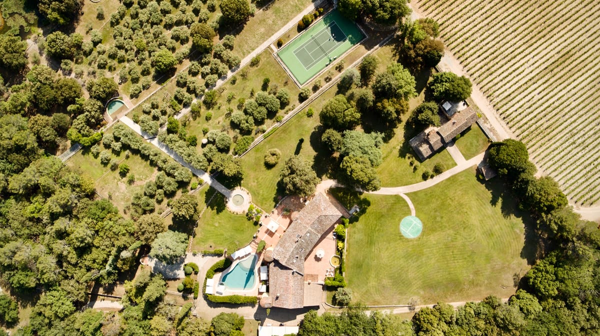 Aerial view of the Chateau les Crostes estate with vineyard, tennis court and pool