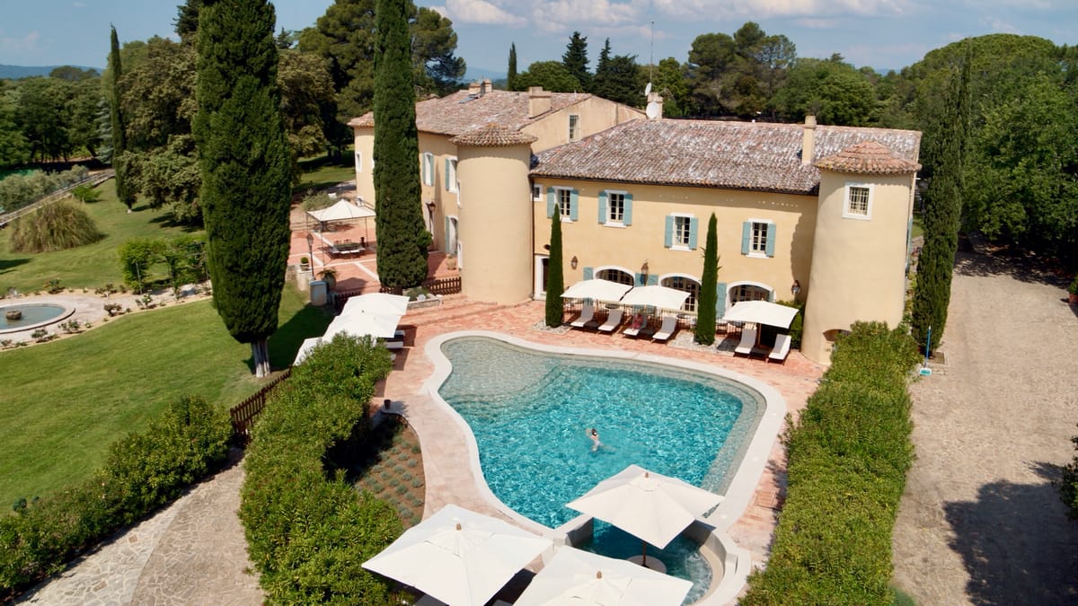 The chateau and swimming pool terrace at Chateau les Crostes from above