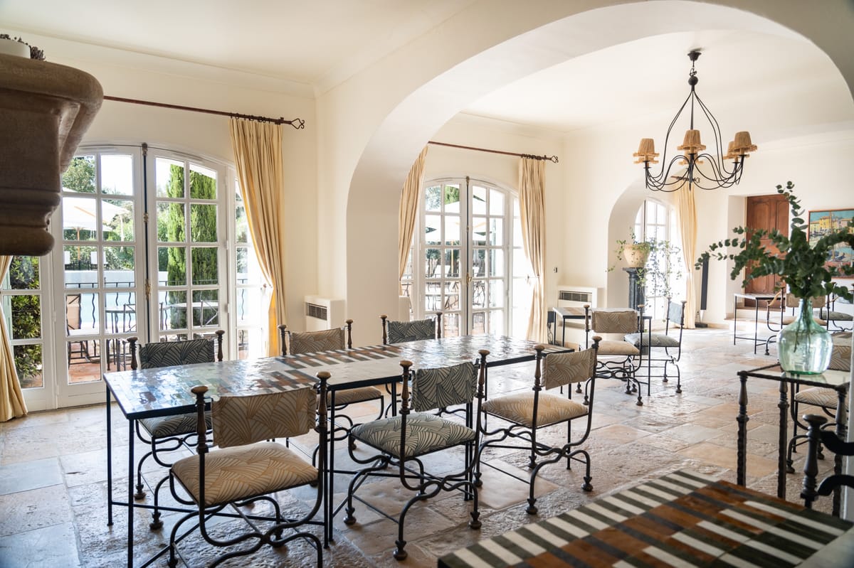 Dining room with stone floors and arched openings at Chateau les Crostes