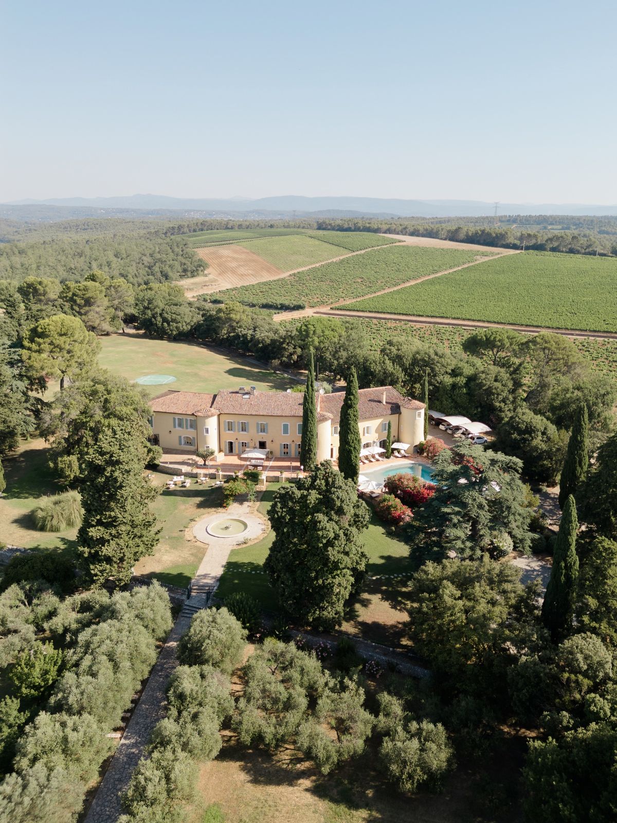 Chateau les Crostes in its Provencal landscape with vineyards beyond