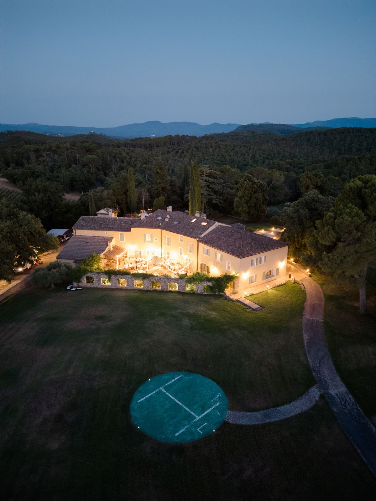 Evening aerial of Chateau les Crostes with the reception terrace lit below