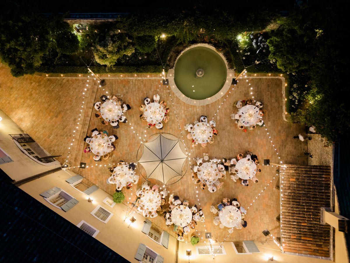 Courtyard wedding dinner and fountain at Chateau les Crostes seen from above