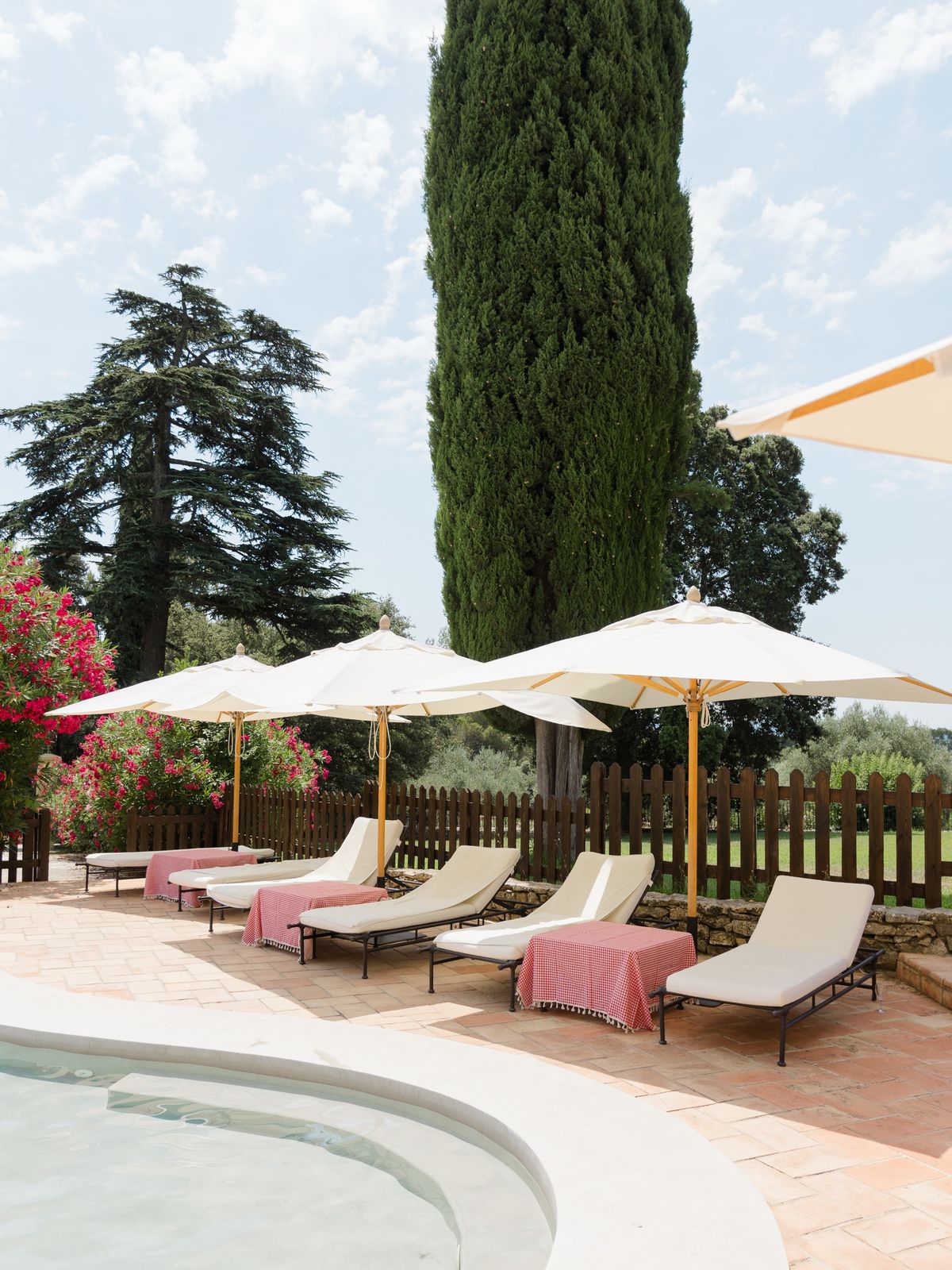 Poolside loungers and parasols at Chateau les Crostes