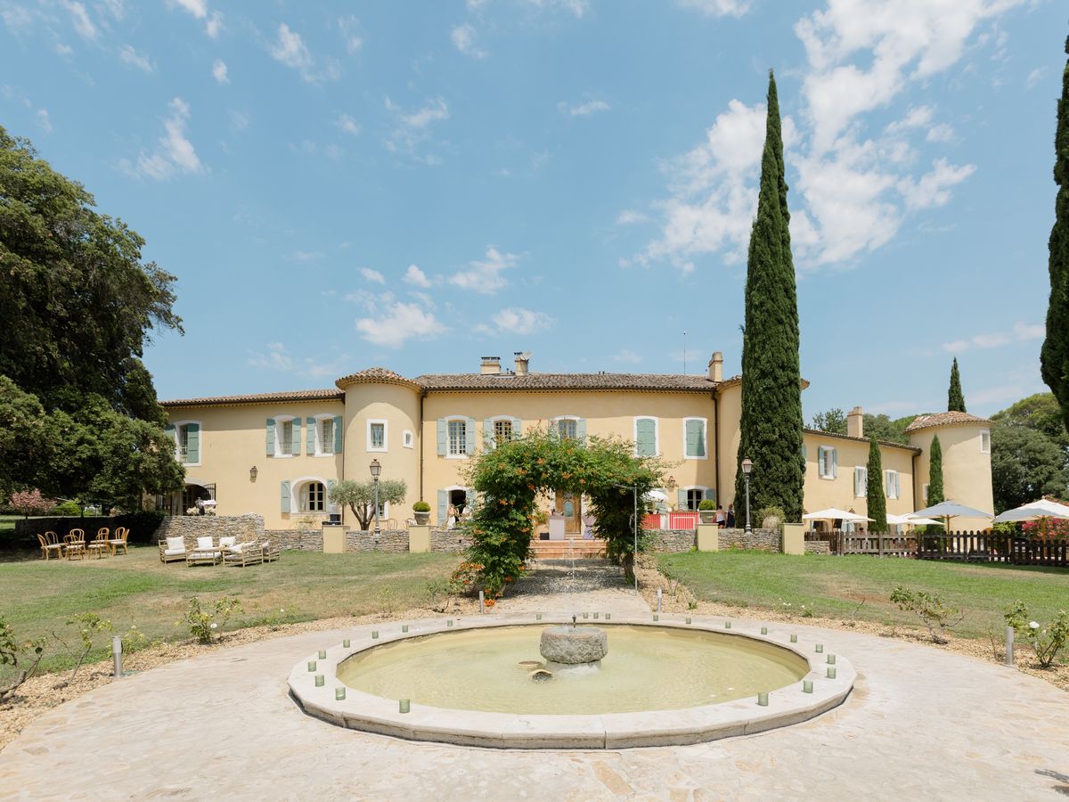 The chateau facade and garden fountain at Chateau les Crostes