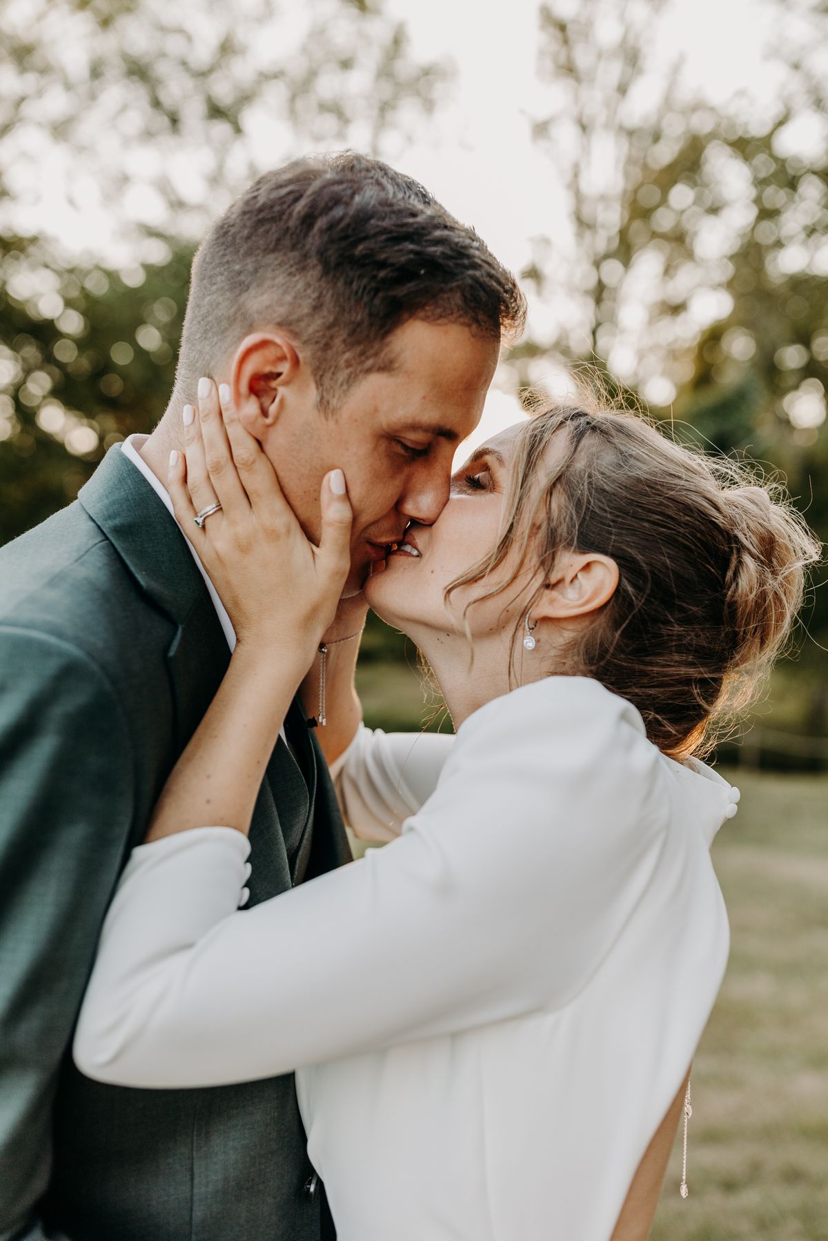 The newlyweds embracing in the estate grounds at golden hour
