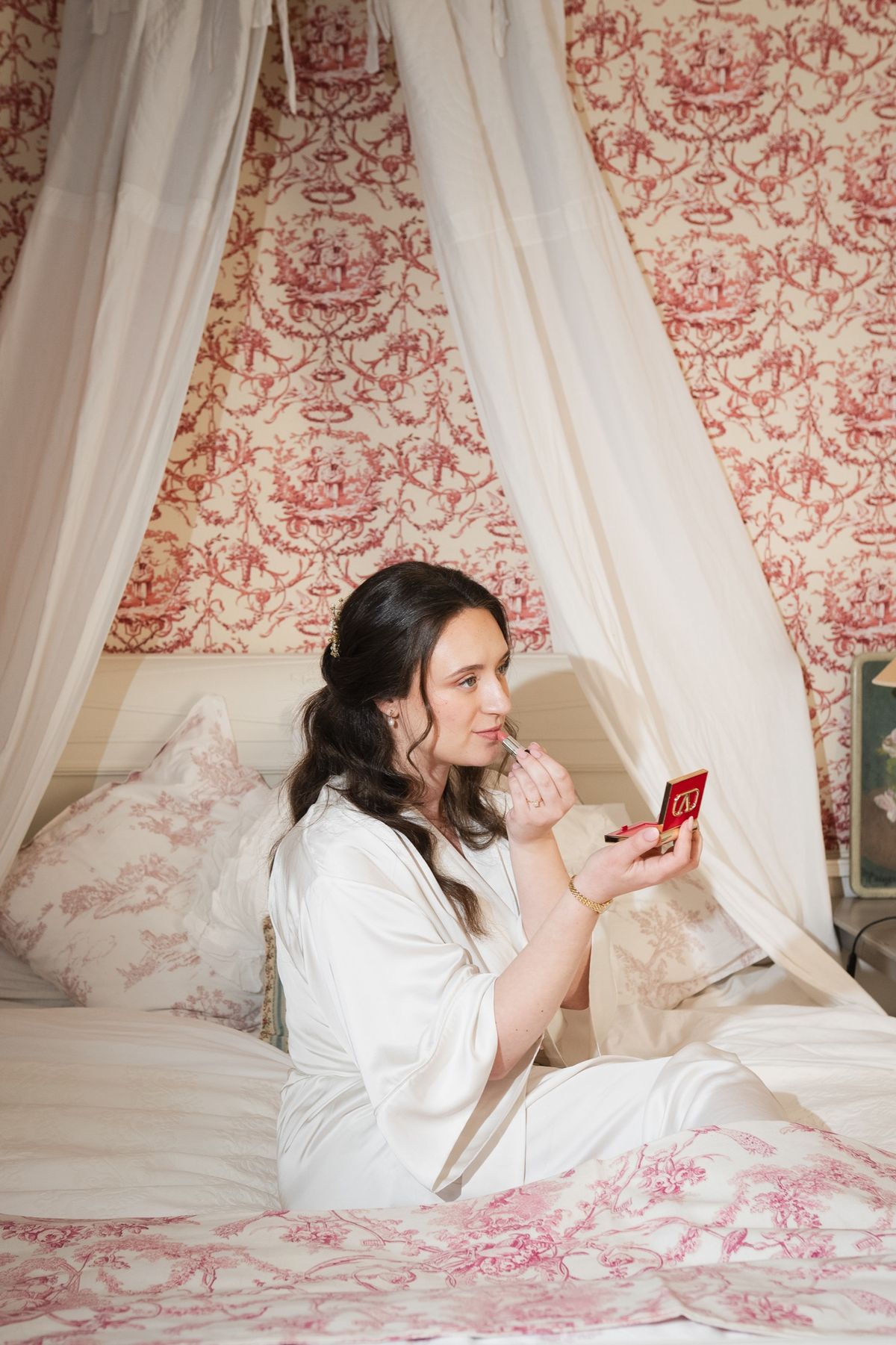 The bridal suite with a canopied bed and pink toile de Jouy walls