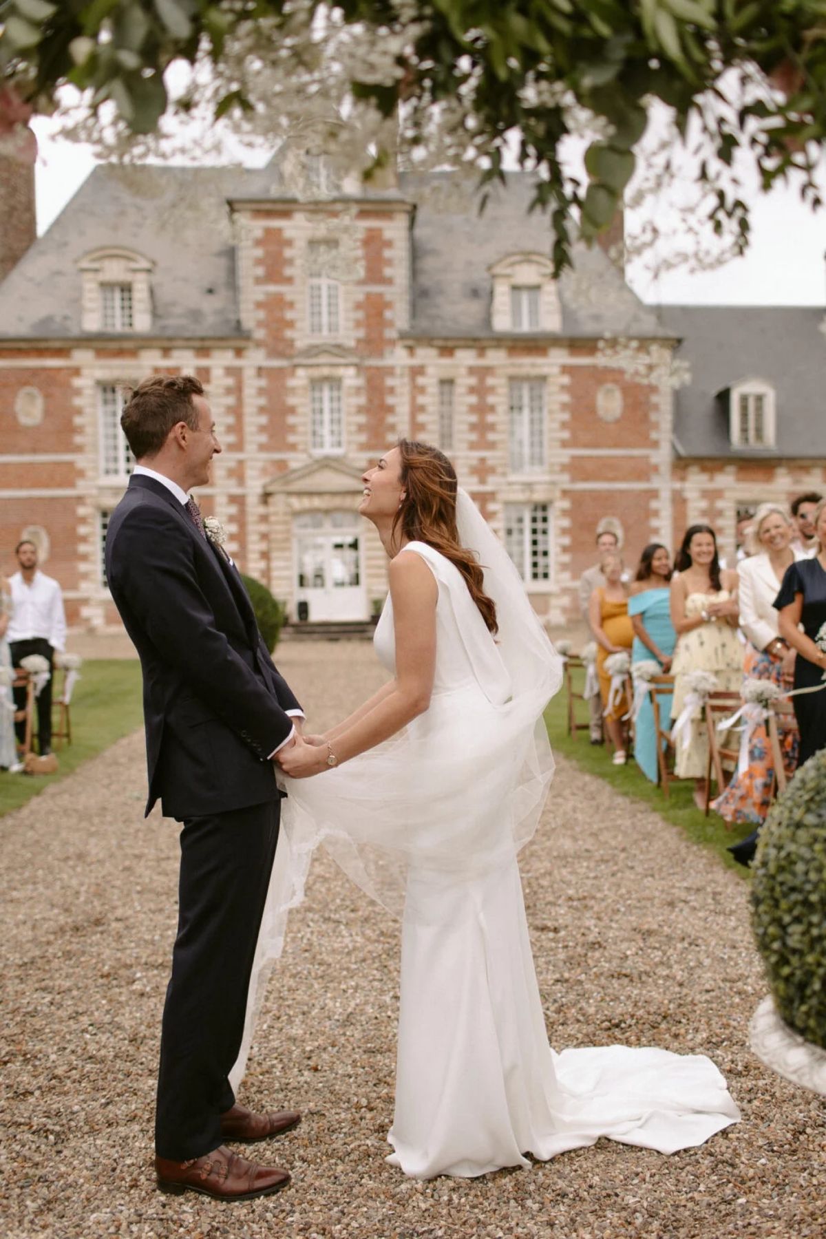 A ceremony held on the gravel forecourt directly in front of the château