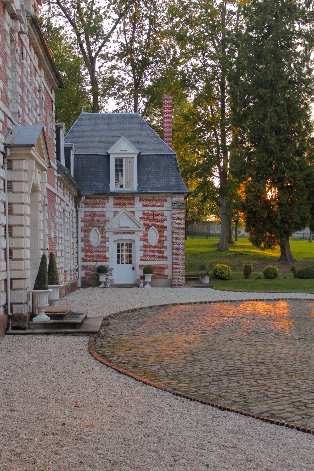 The brick garden pavilion beside the château in late afternoon light