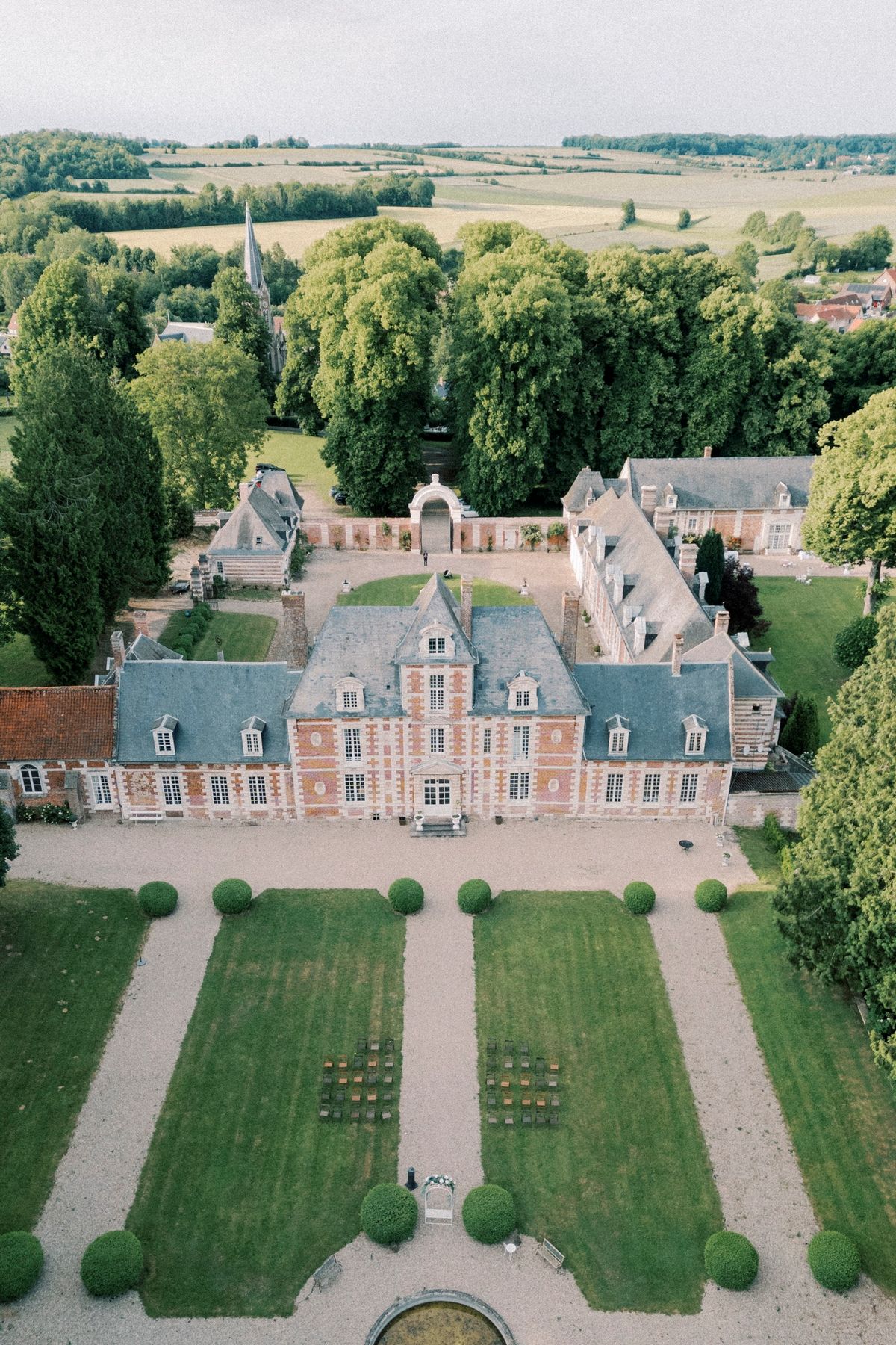 Aerial view of the whole estate showing the château, its courtyard, the formal gardens and the village beyond