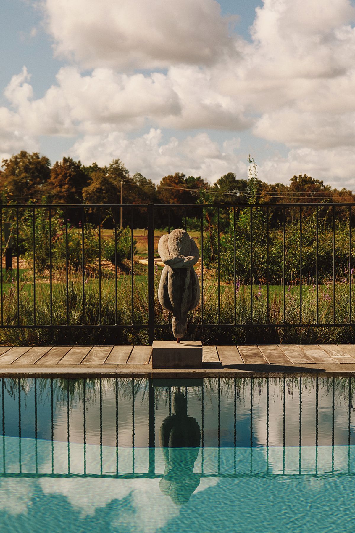 Château de Beaulieu — Pool terrace detail — fence, sculpture