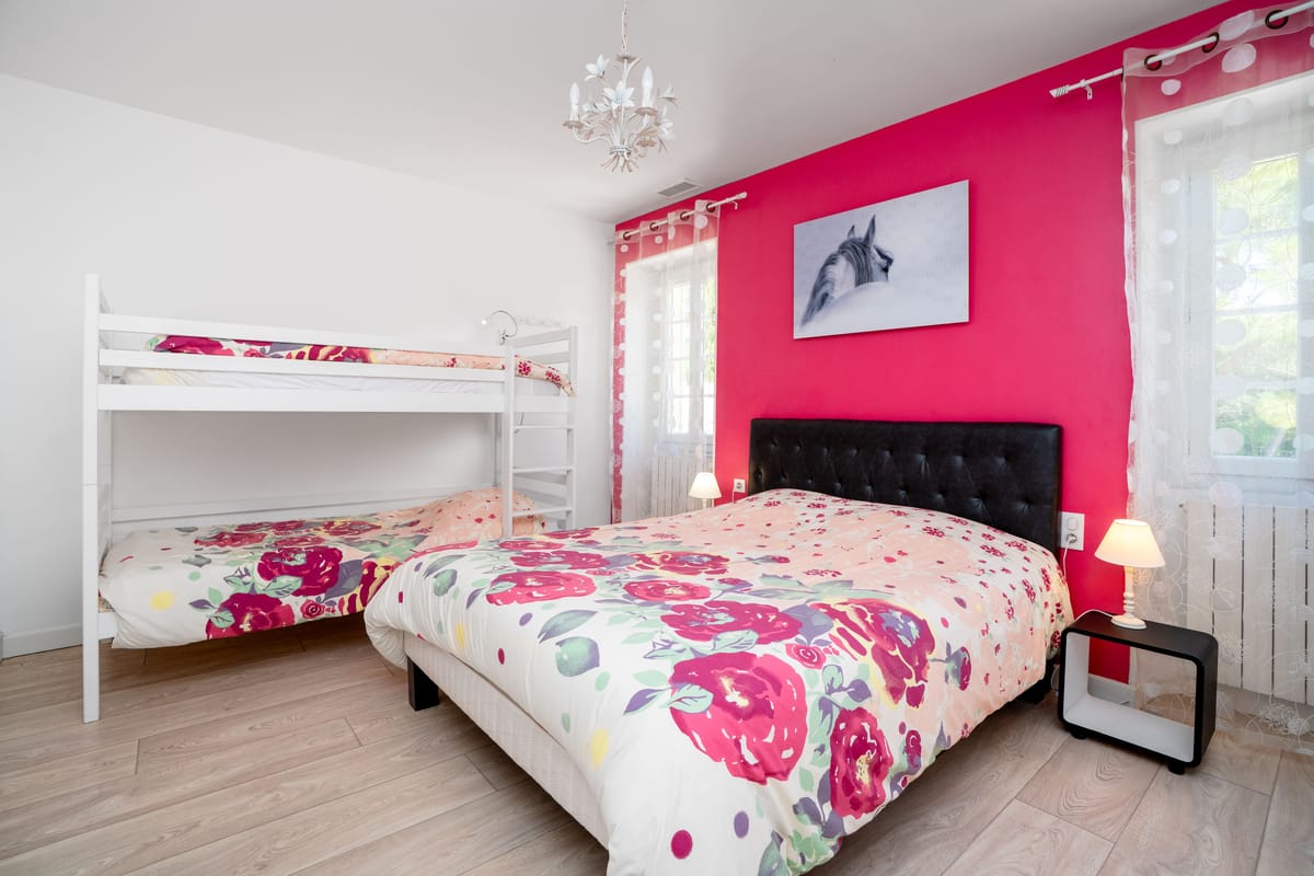 A family bedroom with a double bed and bunk beds.