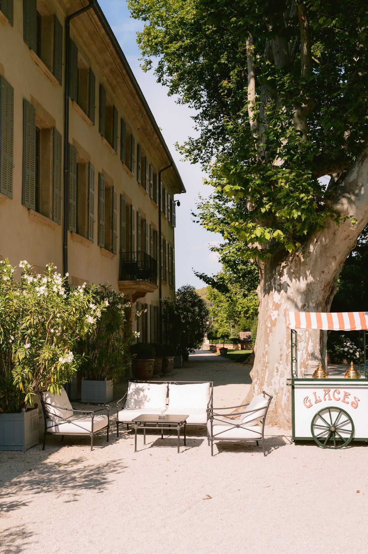 Stone courtyard path lined with lounge chairs at Domaine de Fontenille
