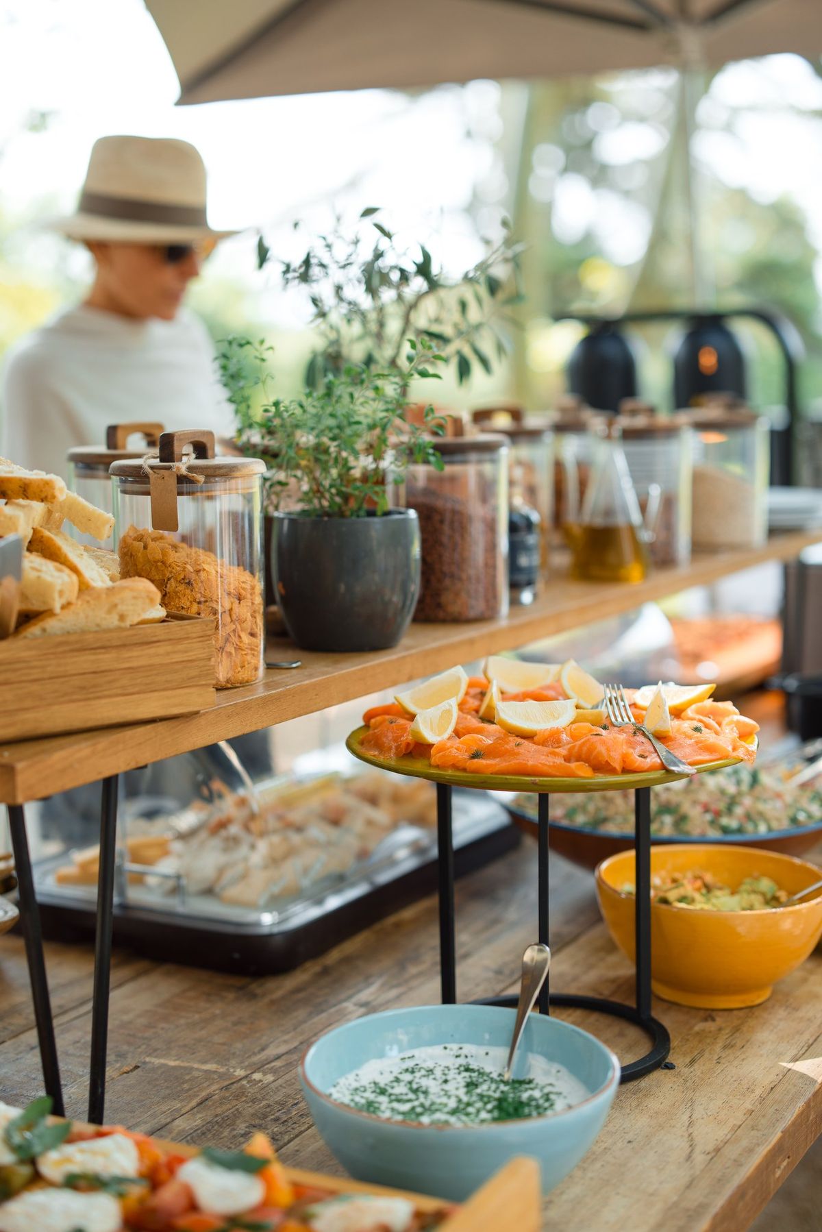 Brunch spread with herbs and preserves laid out on a wooden table