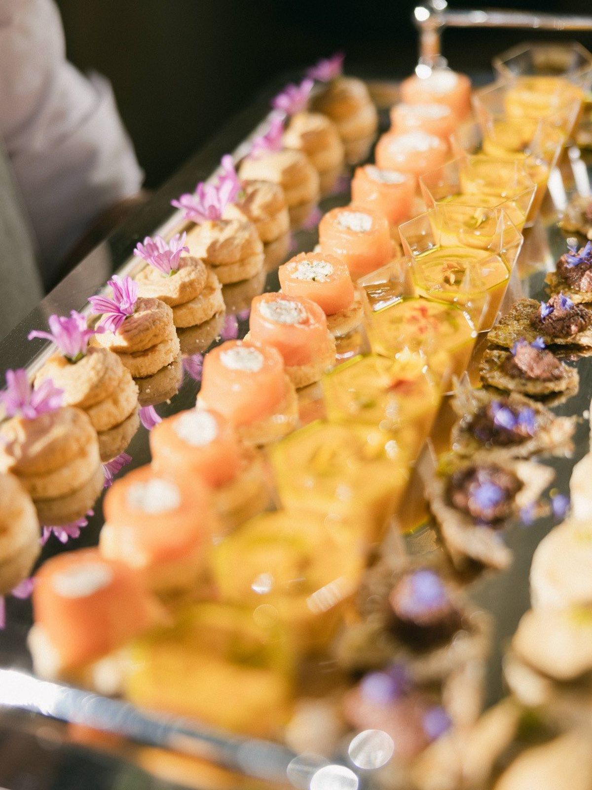 Cocktail hour canapes with edible flowers