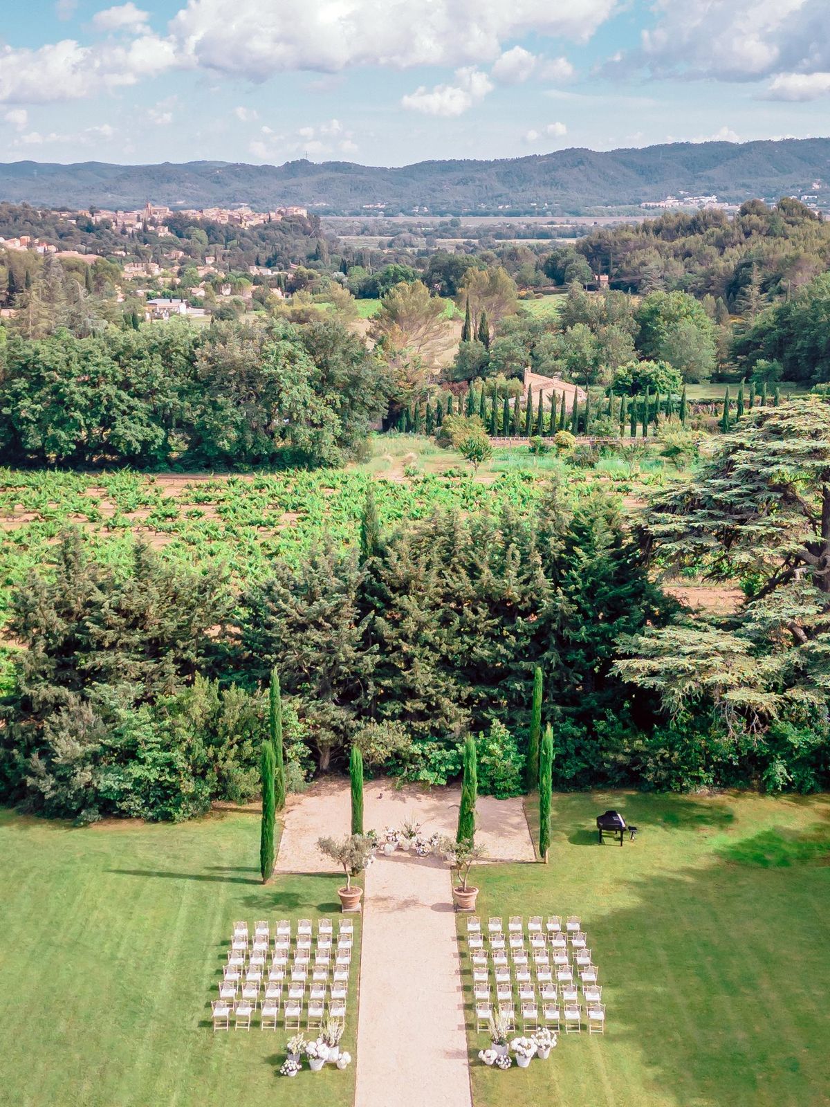 Aerial view of an empty ceremony setup on the lawn with hills beyond