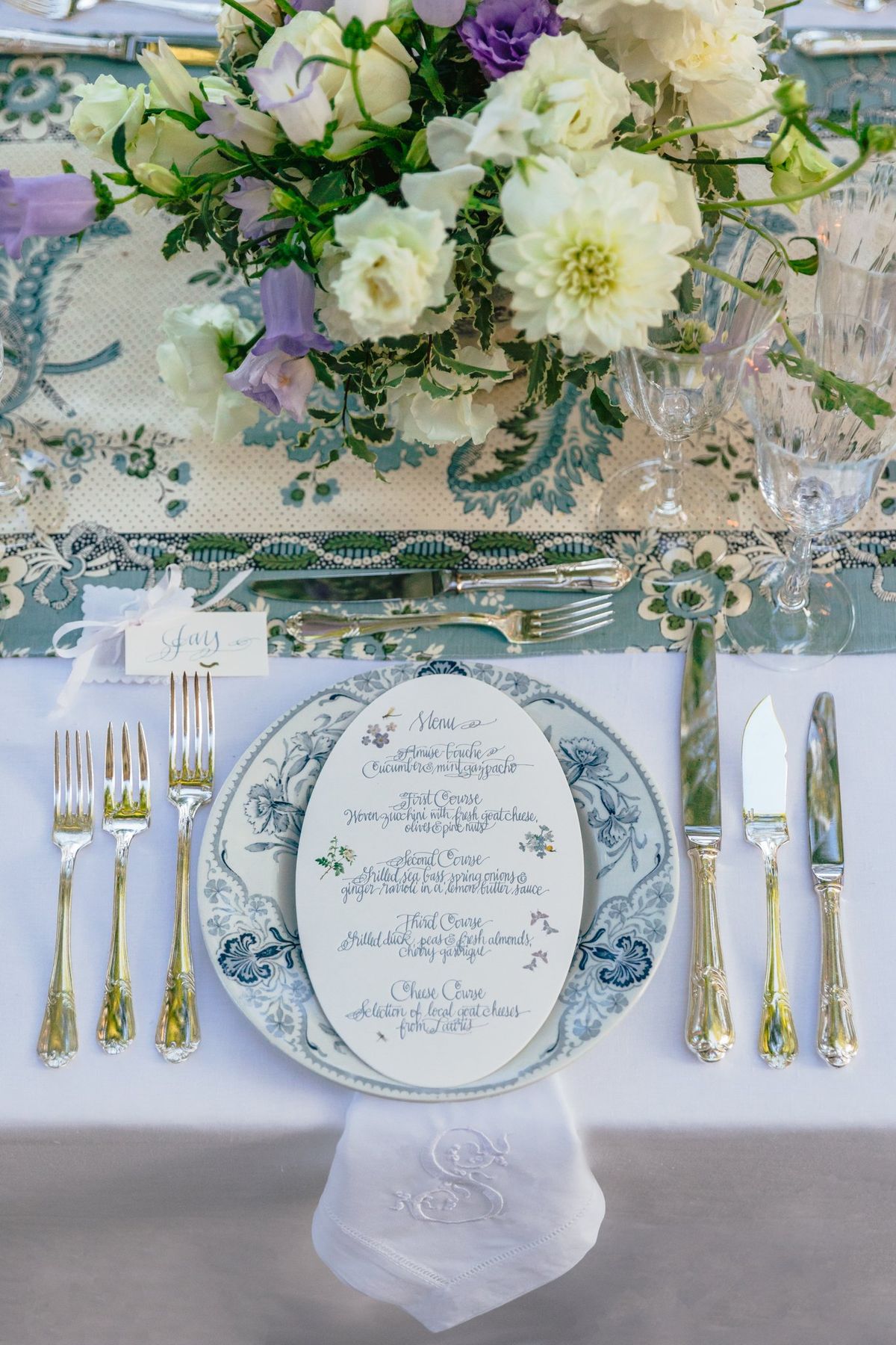 Table setting with white and purple floral centerpiece