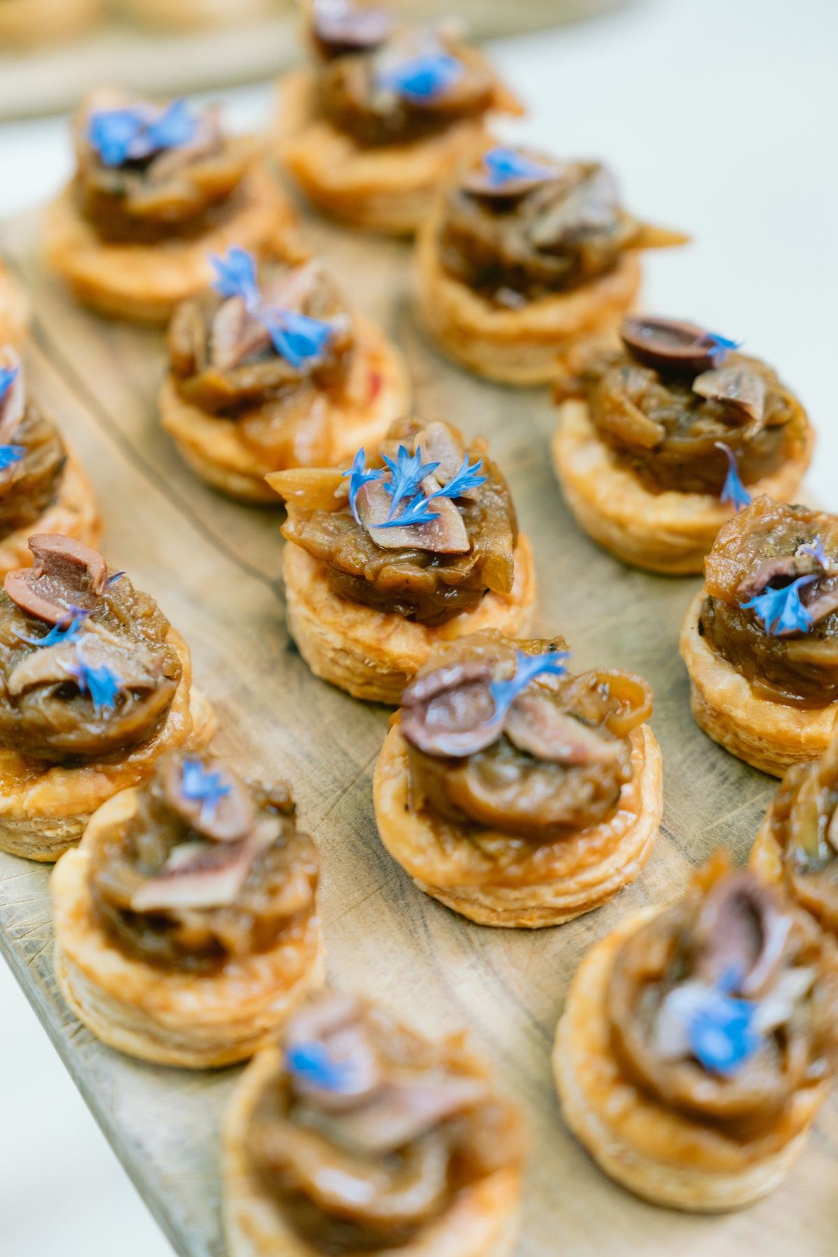 Canapes with edible flowers served on a platter