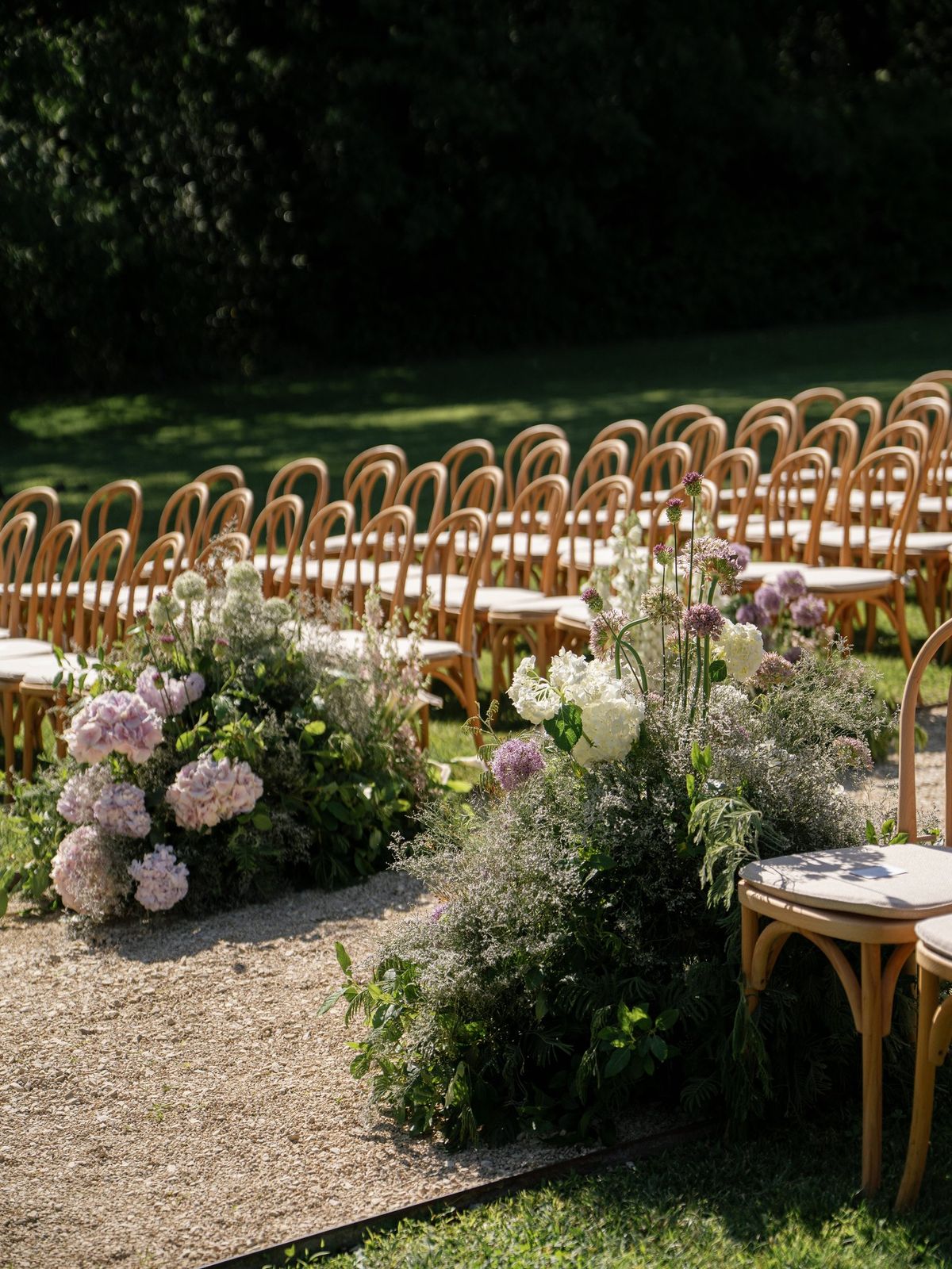 Ceremony aisle lined with floral arrangements