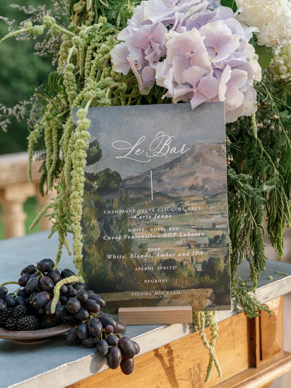 Menu card flatlay with grapes and dried florals