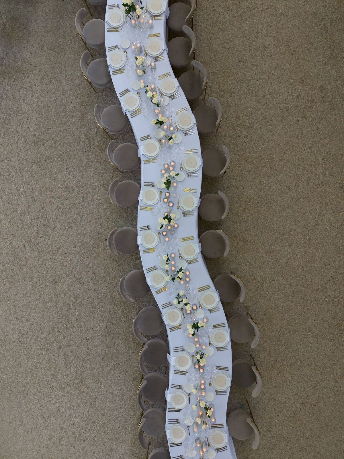 Overhead view of place cards arranged along a table runner