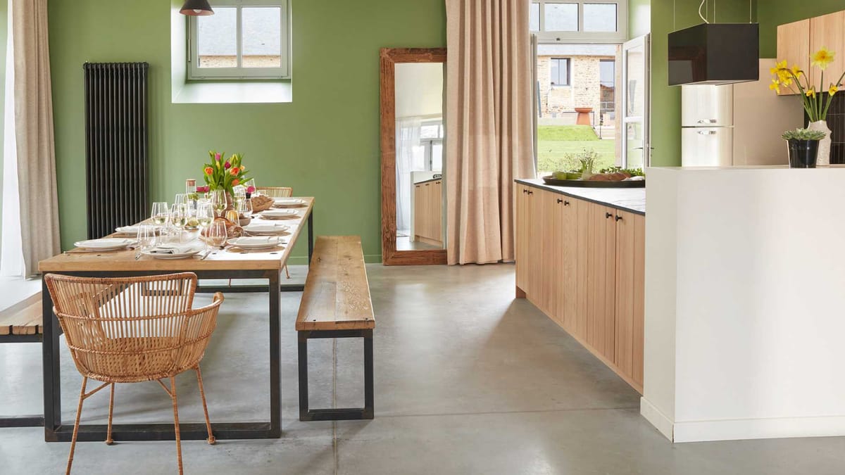 Open plan kitchen and dining room in the accommodation at Domaine Le Mezo with a table laid for lunch