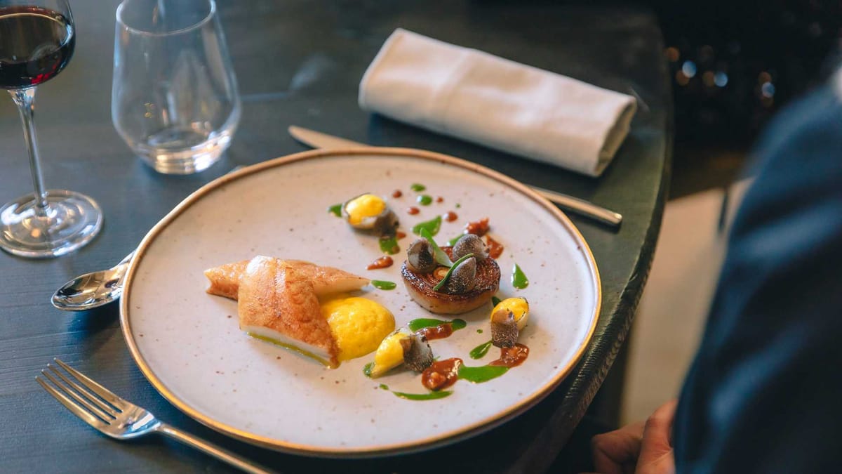 Plated fish course served in the restaurant at Domaine Le Mezo