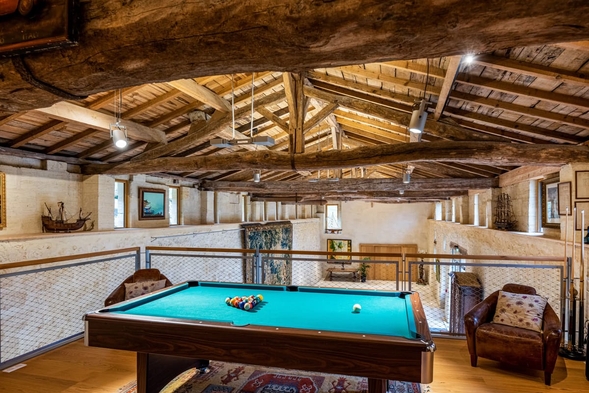 A billiards table on the mezzanine beneath timber roof beams
