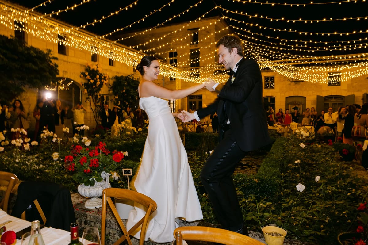 Courtyard reception in the evening beneath strings of festoon lights