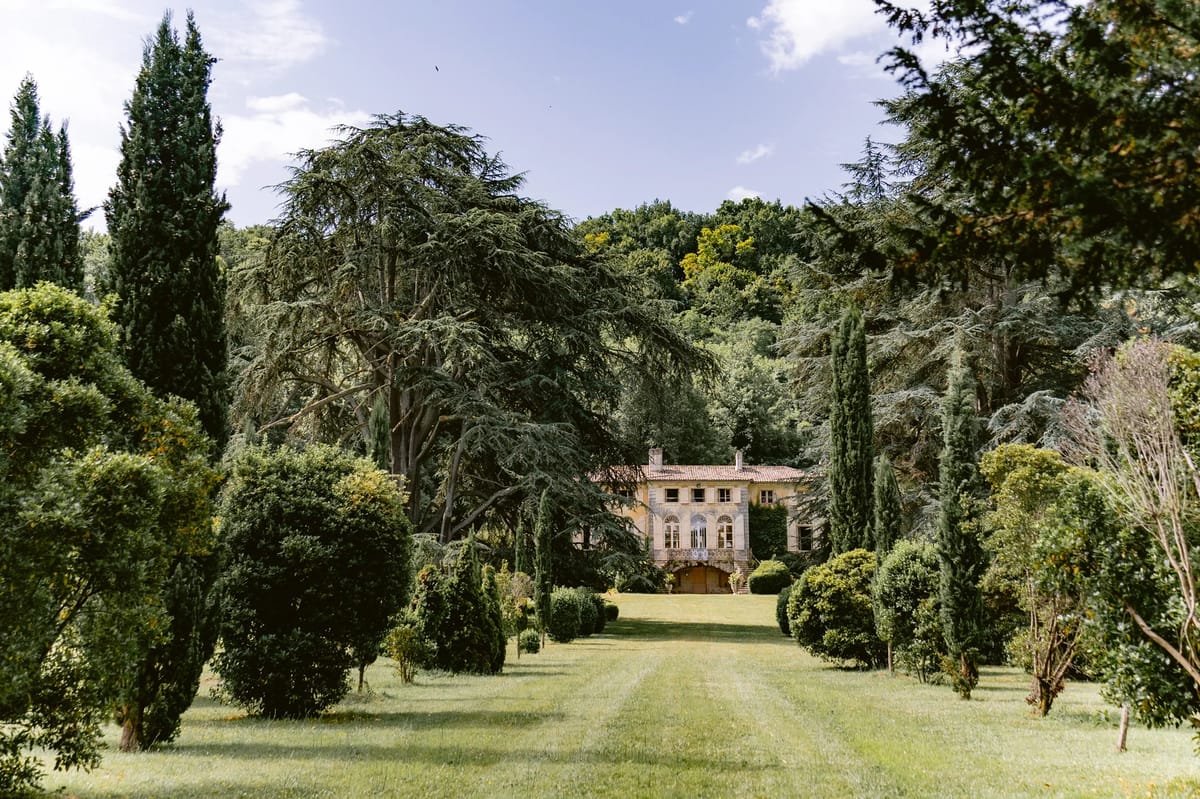 Cypress-lined avenue leading to the chateau facade