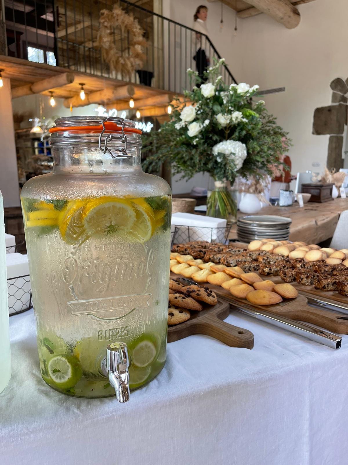 Citronnade dispenser and dessert table set beside the staircase at Les Oliviers de Palombaggia
