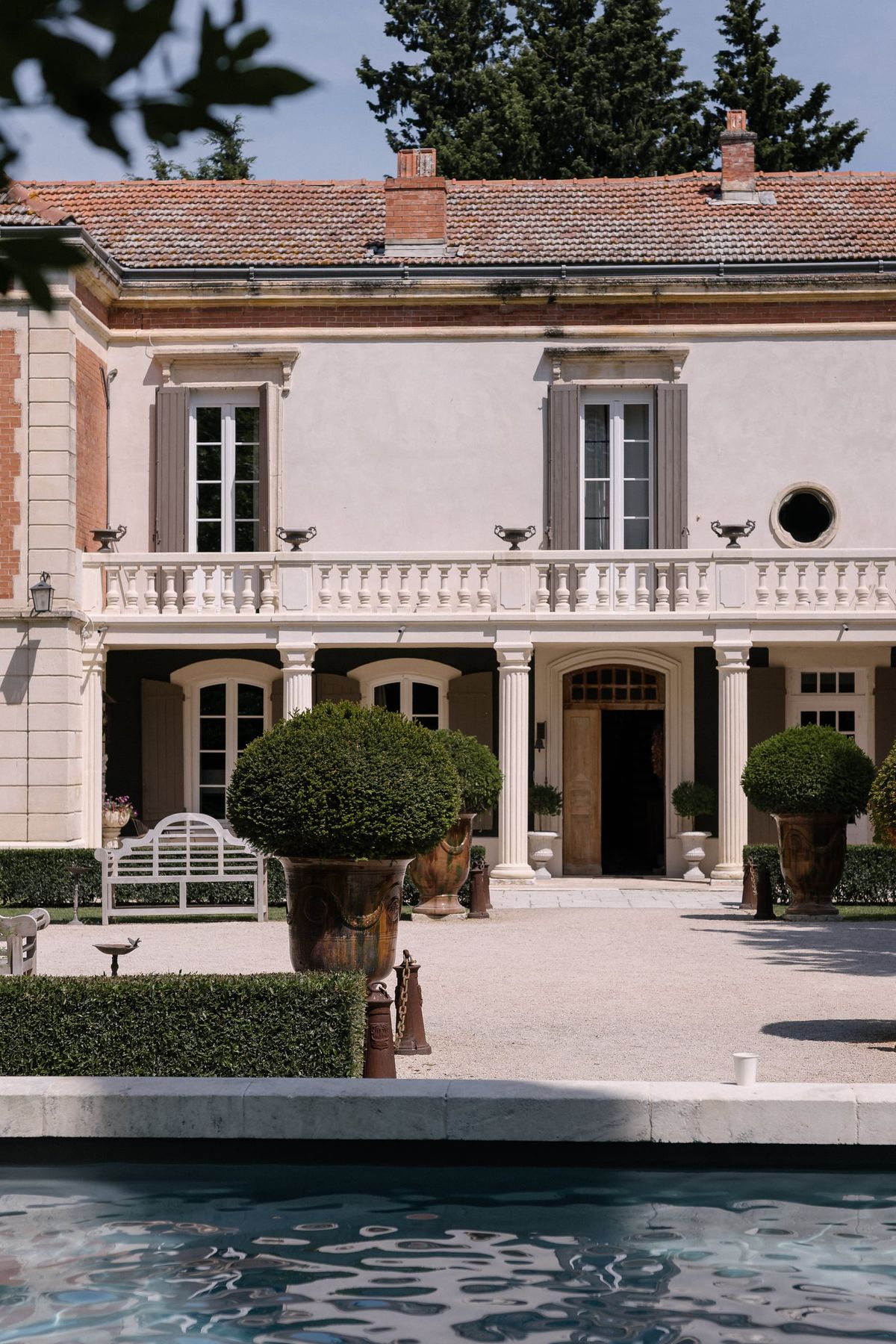 Mas D'Arvieux chateau facade with colonnade terrace and reflecting pool