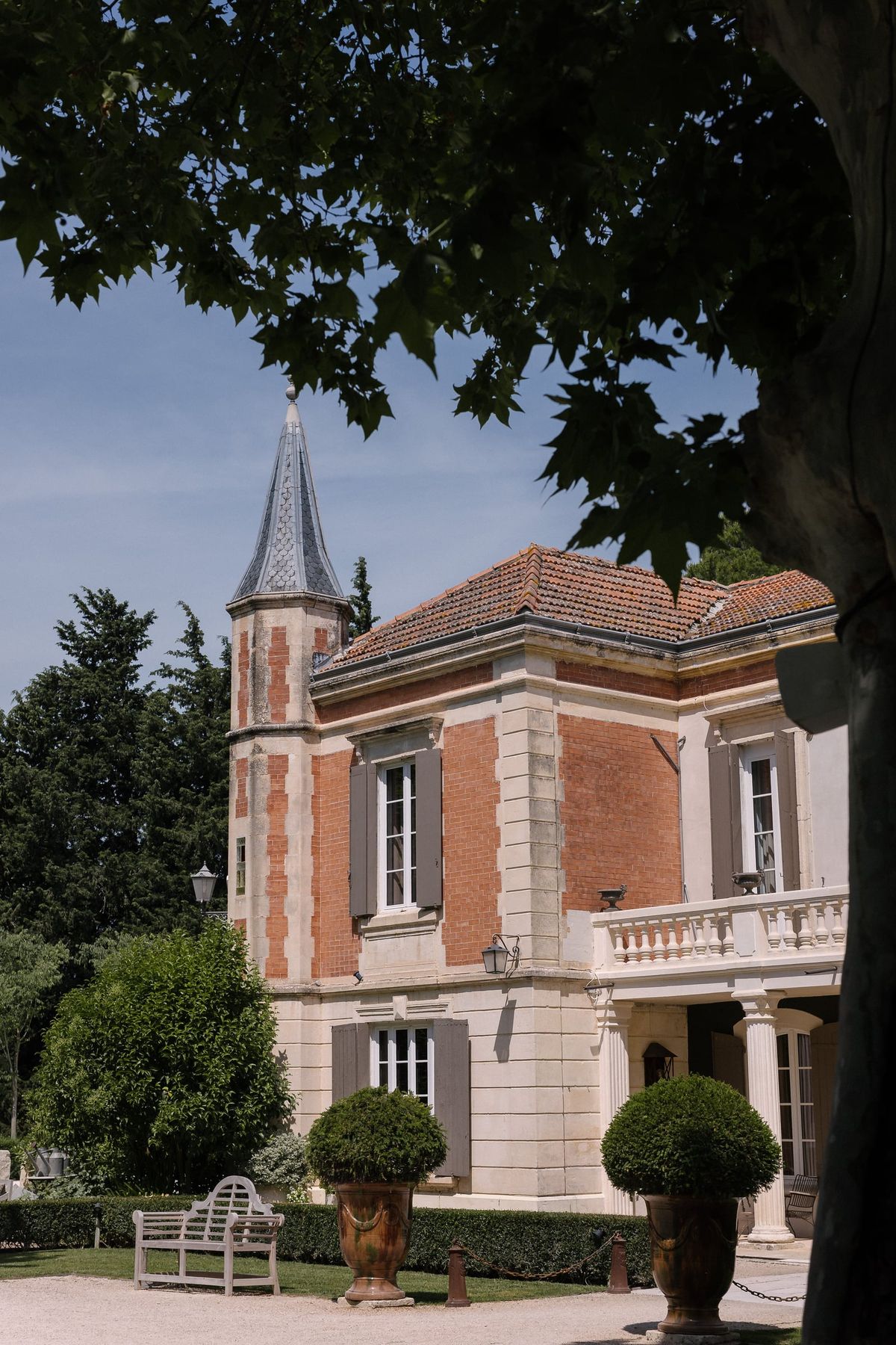 Mas D'Arvieux corner turret and stone facade with garden bench