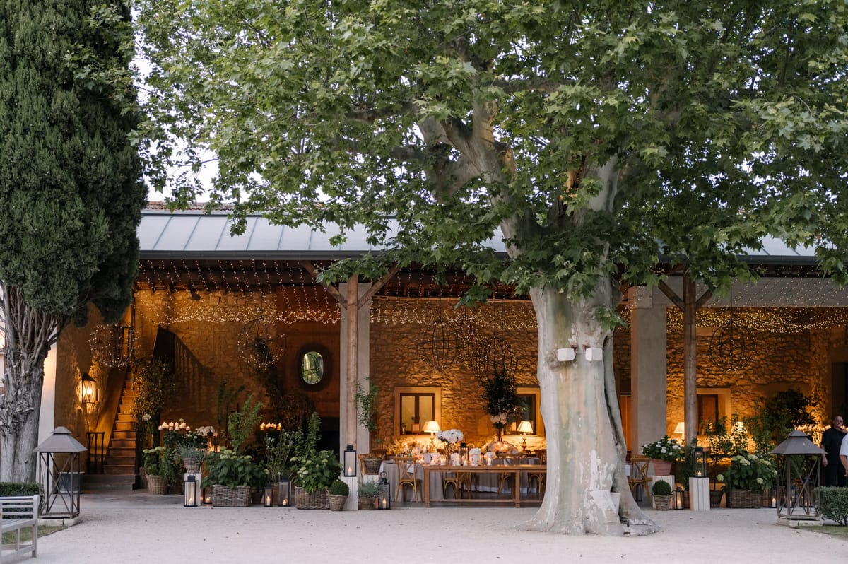 Mas D'Arvieux candlelit reception dinner beneath string lights at dusk