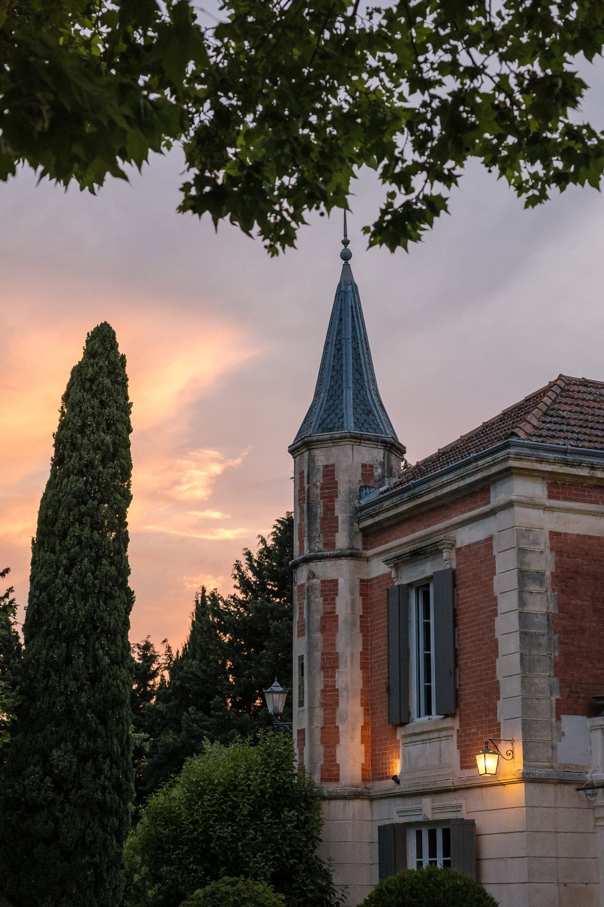 Mas D'Arvieux corner turret silhouetted against a dusk sky