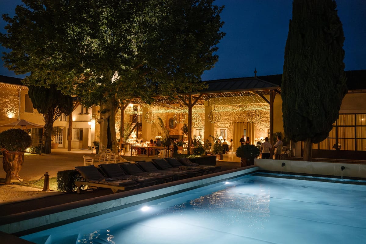 Mas D'Arvieux pool and terrace lit for an evening reception