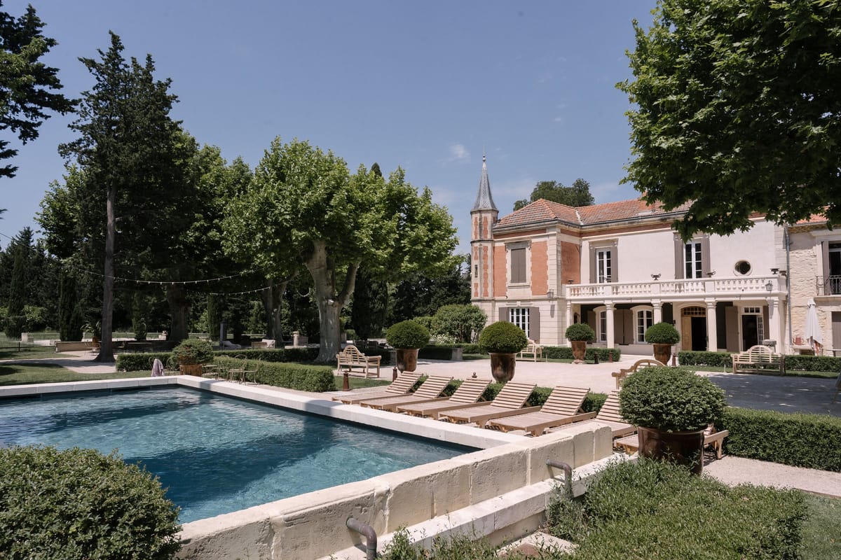 Mas D'Arvieux swimming pool and chateau facade with sun loungers