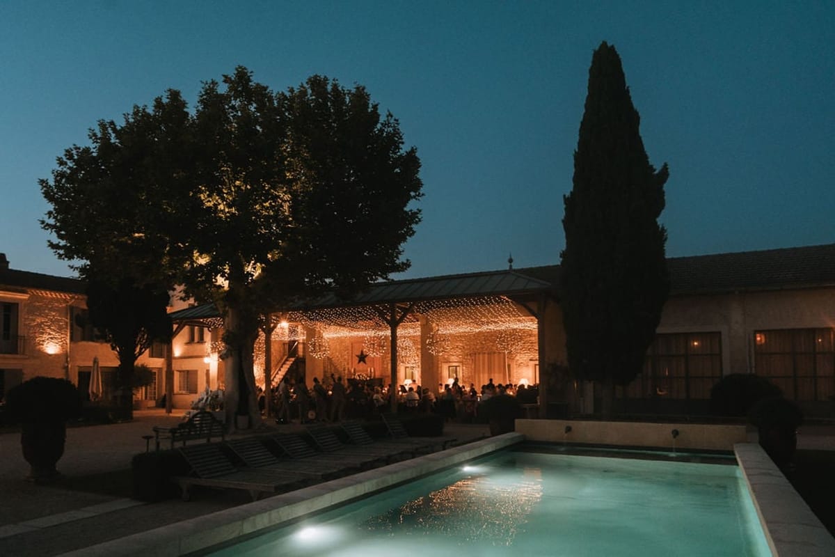 Aerial dusk view of Mas D'Arvieux courtyard reception beneath string lights