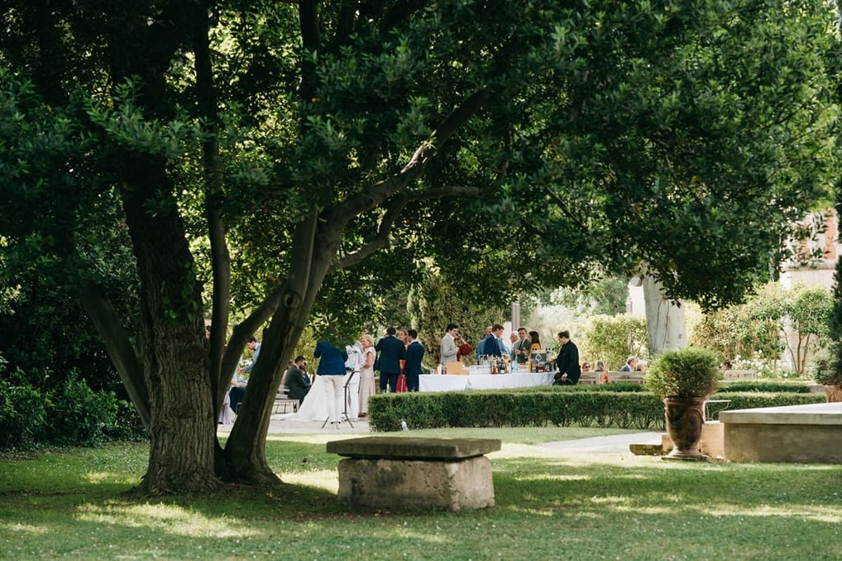 Mas D'Arvieux guests gathered in the gardens beneath shade trees