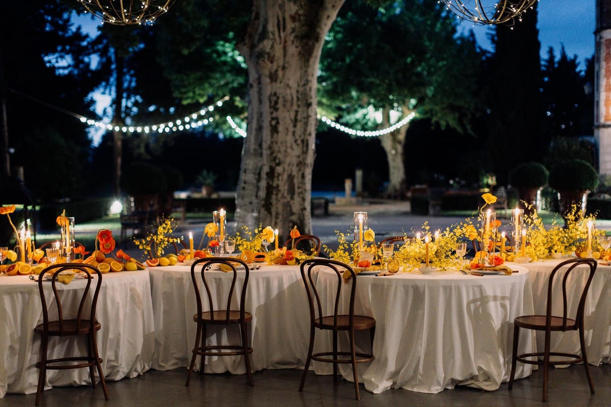 Mas D'Arvieux courtyard reception beneath a fairy-lit plane tree at blue hour