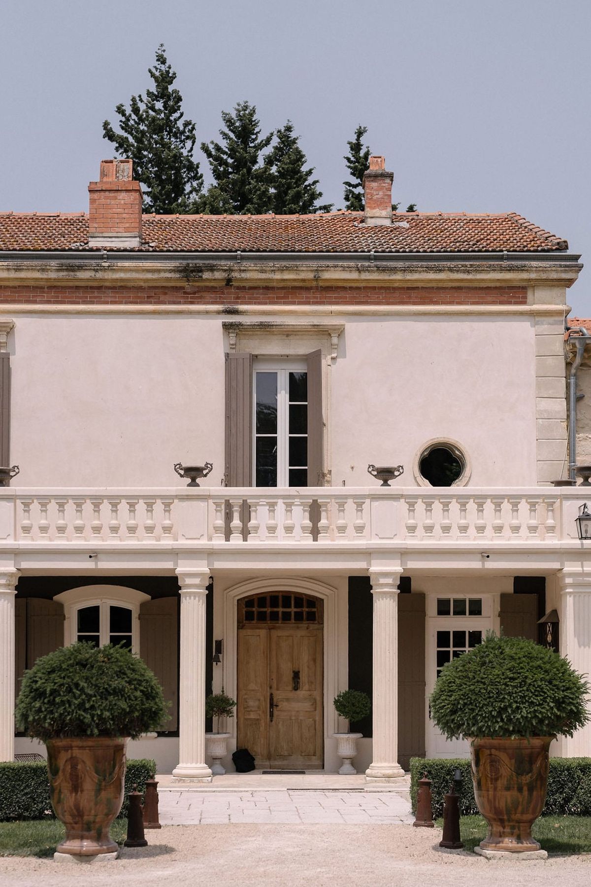 Mas D'Arvieux entrance colonnade with fluted columns and wooden front door