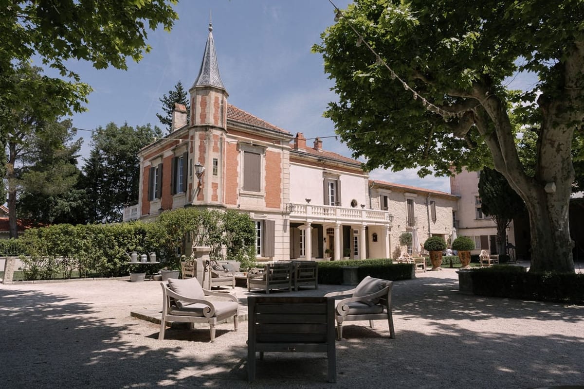 Mas D'Arvieux lounge courtyard with garden furniture beneath a plane tree