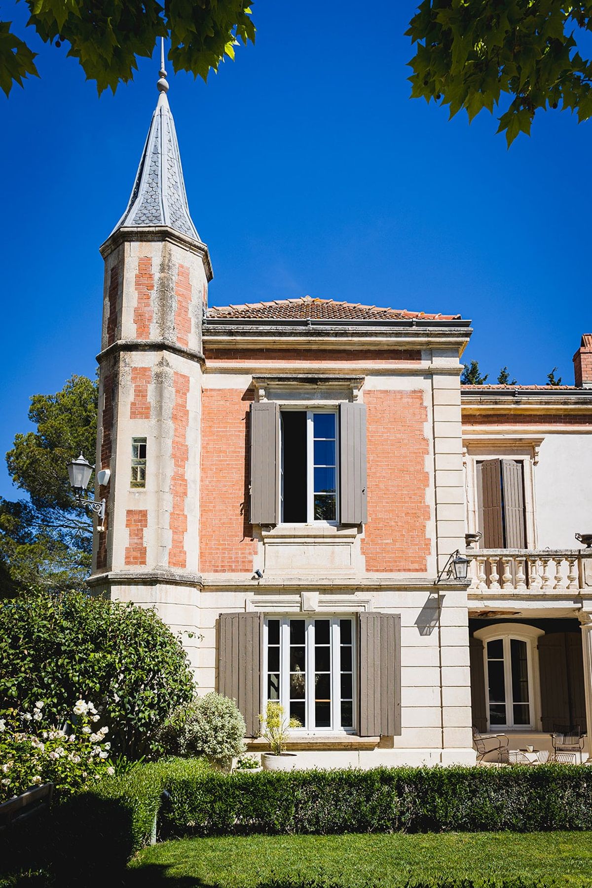 Mas D'Arvieux corner turret against a clear blue sky