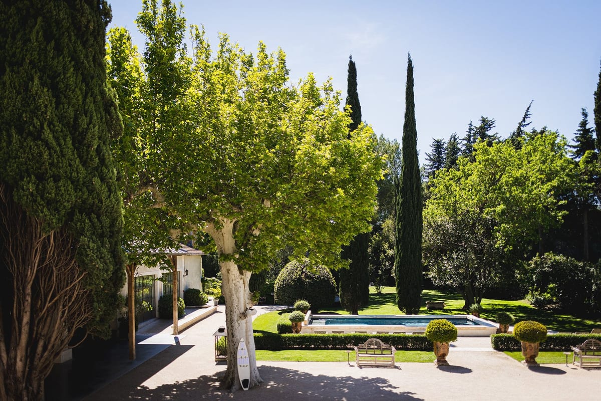 Mas D'Arvieux courtyard lounge beneath a plane tree beside the swimming pool